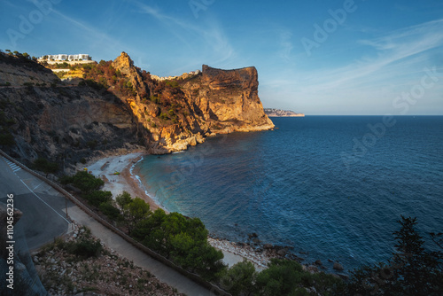 The rock rises above the blue sea