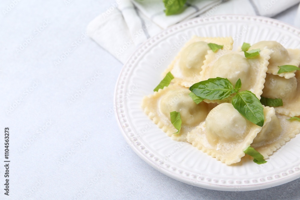 Delicious ravioli with cheese and basil served on light table, closeup. Space for text Delicious ravioli with cheese and basil served on light table, closeup. Space for text