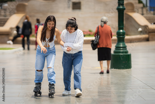 Young woman helping her disabled friend learning to skate in a city park