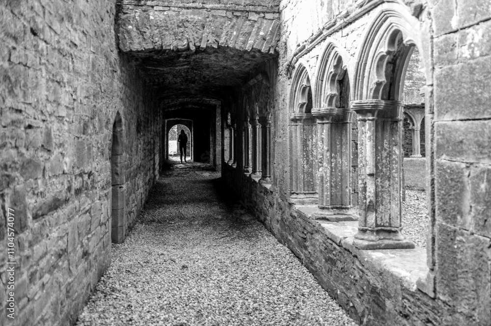 Fototapeta premium A long, narrow hallway with a person walking down it