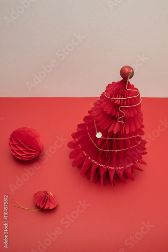 Necklace of golden chane on a red paper Christmas honeycomb tree. photo