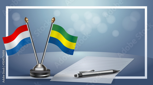 Netherlands and Gabon Small national flag on bokeh background, cooperative relationship