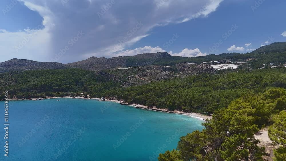 A scenic beachfront bay in Antalya, Turkey, surrounded by forested hills and majestic mountains, offering breathtaking coastal views. A scenic beachfront bay in Antalya, Turkey, surrounded by forested hills and majestic mountains, offering breathtaking coastal views.