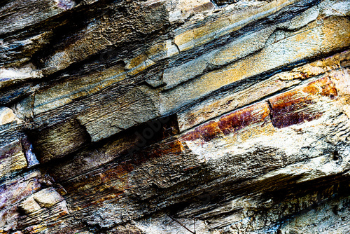 Nature force compressed cracked rock layers structure formation close-up details, in various shapes, colors, thicknesses, at north central coast of Crete, Greece. Nature and Geological science concept