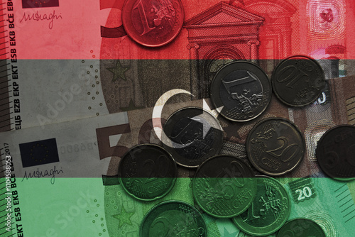 colourful national flag of libya on a euro money banknotes and coins background. finance concept. photo