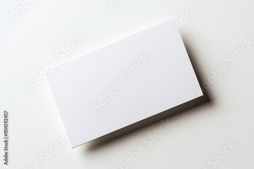 A white business card sits on a white background