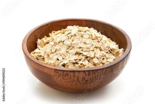 Bowl of oatmeal is sitting on a white background. The bowl is wooden and filled with oatmeal