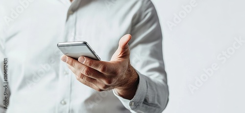 Man using smartphone with light skin in gray shirt pointing at screen on white background