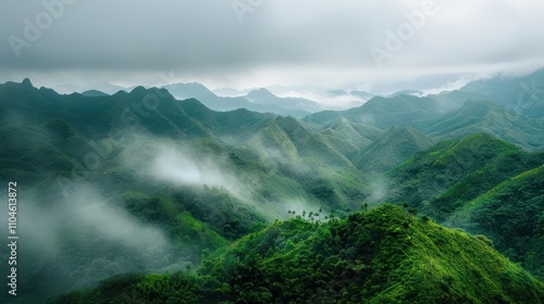 panoramic view of lush green mountains and green trees with a little mist