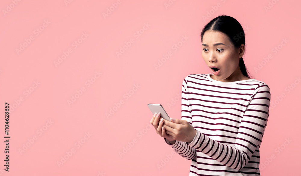 Bad Message. Young Asian Woman Looking At Smartphone With Shock, Reading Unpleasant Sms, Portrait Of Emotional Korean Female With Cellphone In Hands Standing Over Pink Studio Background, Free Space Bad Message. Young Asian Woman Looking At Smartphone With Shock, Reading Unpleasant Sms, Portrait Of Emotional Korean Female With Cellphone In Hands Standing Over Pink Studio Background, Free Space
