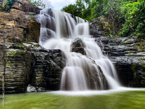 beautiful view of a waterfall in the middle of the forest