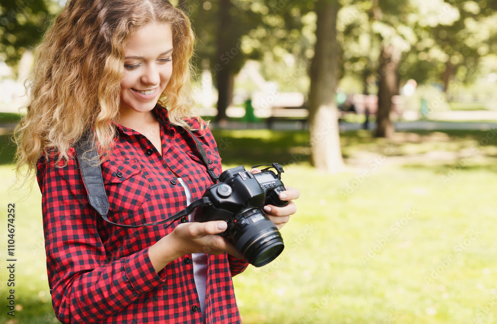 Young female student taking photos in the park with camera. Photography classes, education and remote working concept, copy space, closeup Young female student taking photos in the park with camera. Photography classes, education and remote working concept, copy space, closeup