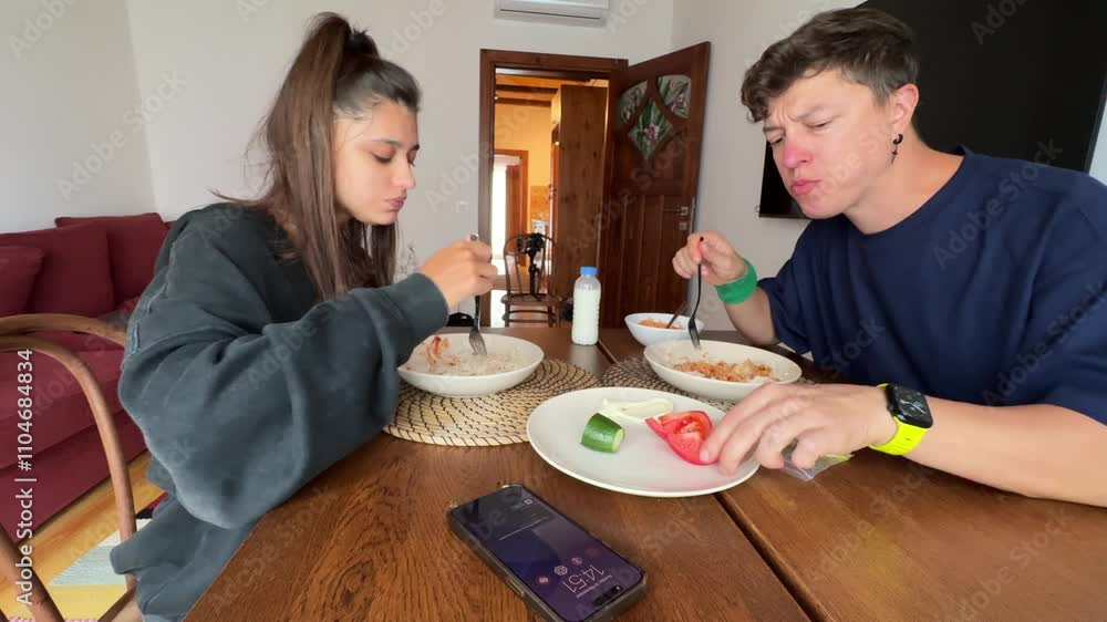 Enjoying a Casual Dining Experience with Friends at Home While Sharing Delicious Food Enjoying a Casual Dining Experience with Friends at Home While Sharing Delicious Food