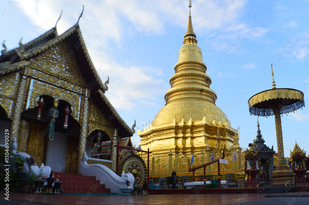 Fototapeta premium Church and Golden Pagoda Lanna Architecture in night at Wat Phra That Hariphunchai ,Symbols of Buddhism, at Lamphun Northern Thailand,South East Asia