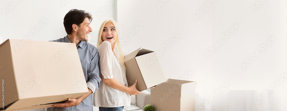 Excited Spouses Carrying Moving Boxes Smiling Looking At Each Other Leaving Old Flat. Free Space Excited Spouses Carrying Moving Boxes Smiling Looking At Each Other Leaving Old Flat. Free Space