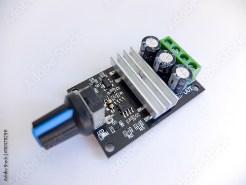 DC Motor speed controller board that regulates motor speed on a white background photo