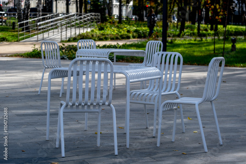 A table with chairs on the playground in the park.