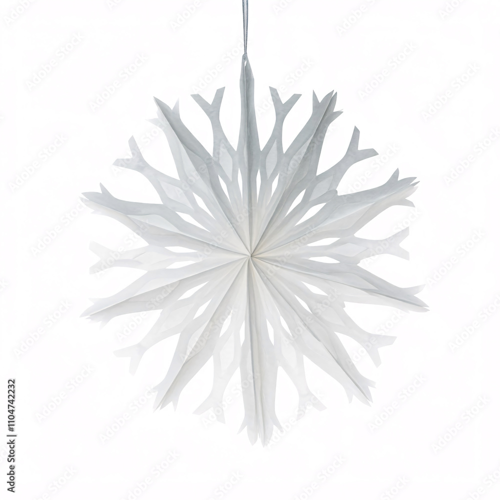 A delicate paper snowflake, hanging against a white background A delicate paper snowflake, hanging against a white background