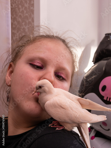 Russia, Moscow region, 04/25/2024. Turtledove is sitting in the girl's arms. A child with a pigeon.