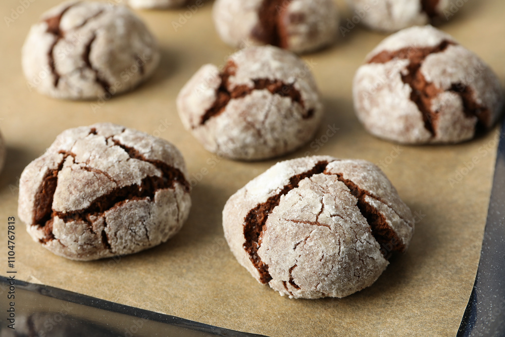 Appetizing crinkle cookies, on parchment, on a dark background. Appetizing crinkle cookies, on parchment, on a dark background.