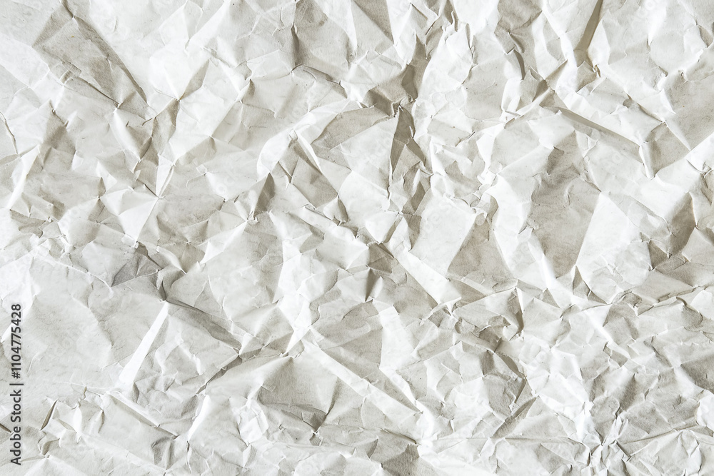 Closeup of a crumpled blank sheet of old paper with a rough, textured surface, perfect for vintage designs and backgrounds. Closeup of a crumpled blank sheet of old paper with a rough, textured surface, perfect for vintage designs and backgrounds.