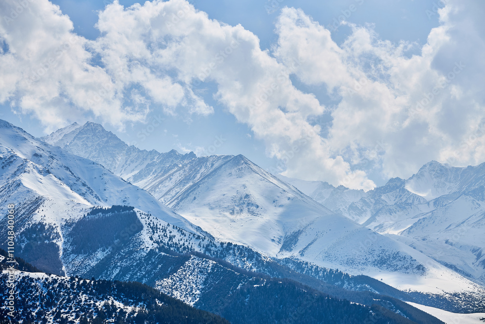 Snow capped hills, mountains. Chunkurchak valley in Kyrgyzstan. Winter natural landscape, mountain range wallpaper, panoramic view. Epic blue sky with white beautiful clouds Snow capped hills, mountains. Chunkurchak valley in Kyrgyzstan. Winter natural landscape, mountain range wallpaper, panoramic view. Epic blue sky with white beautiful clouds