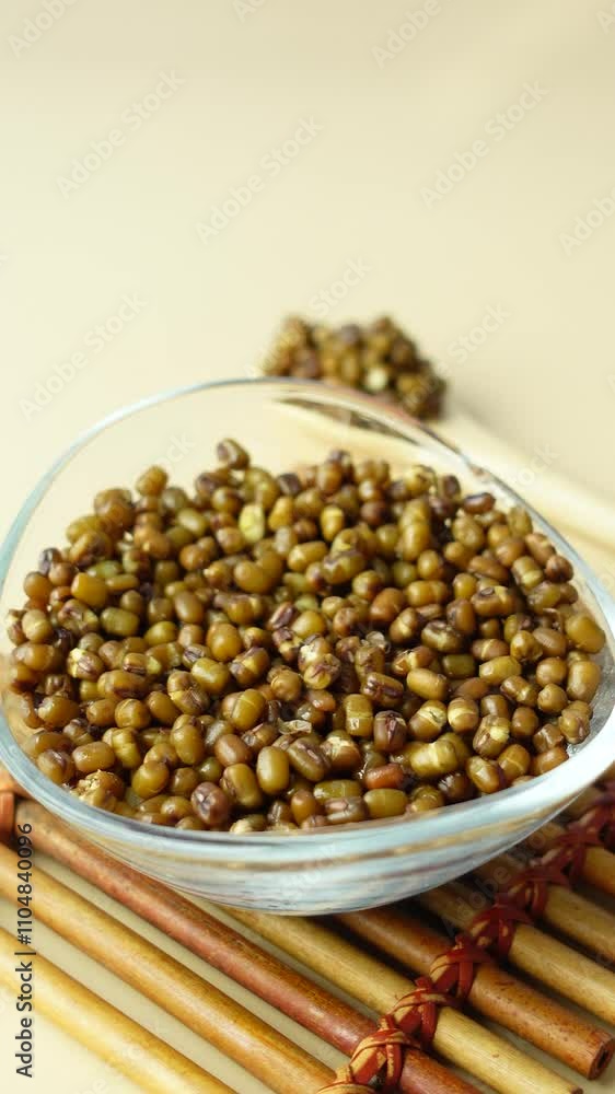 Delicious Cooked Mung Beans sitting in a Glass Bowl, ready to be stirred with a Wooden Spoon Delicious Cooked Mung Beans sitting in a Glass Bowl, ready to be stirred with a Wooden Spoon