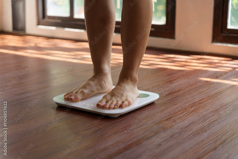 Fat diet and scale feet standing on electronic scales for weight control. Measurement instrument in kilogram for a diet control Fat diet and scale feet standing on electronic scales for weight control. Measurement instrument in kilogram for a diet control