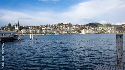 Urban landscape of Lucerne, Switzerland, viewed from the shores of Lake Lucerne on a bright and sunny spring day, showcasing the city’s charm and natural beauty.