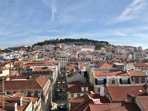 Lisbon, PORTUGAL - February 17, 2017: city skyline filled with red-roofed houses on a hill photo