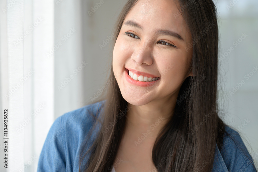Close up a young asian woman face smiling at home Close up a young asian woman face smiling at home