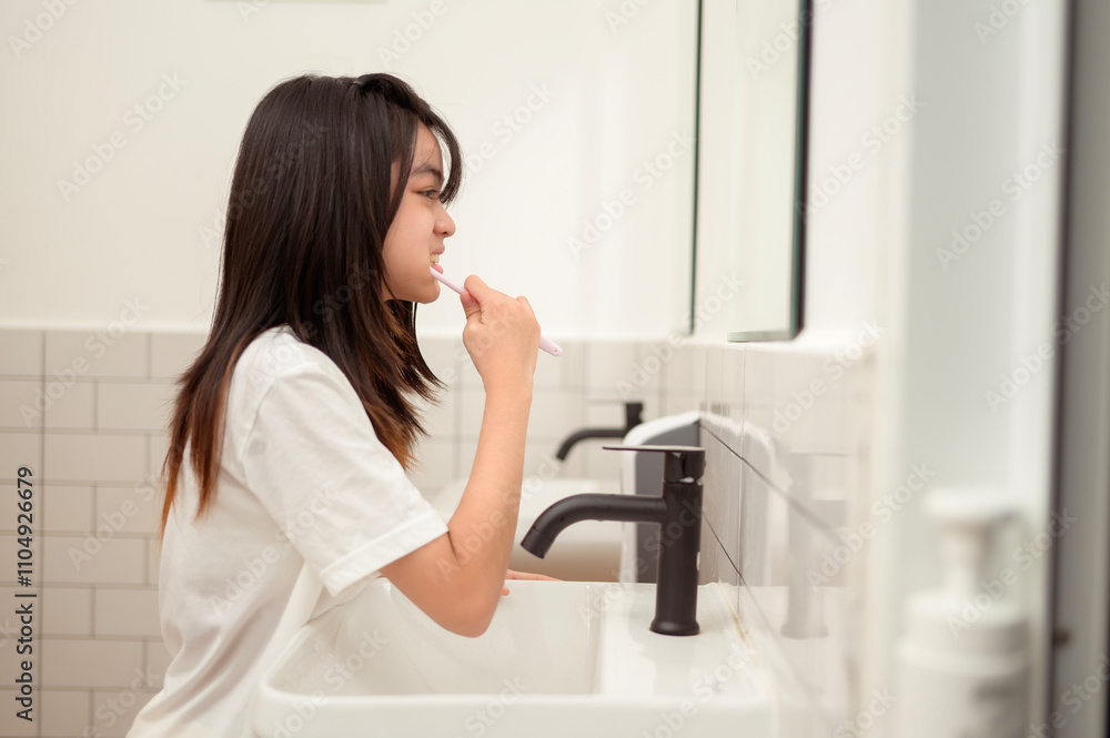 A young woman brushing her teeth in restroom A young woman brushing her teeth in restroom