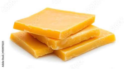 Three square blocks of yellow beeswax isolated on white background.