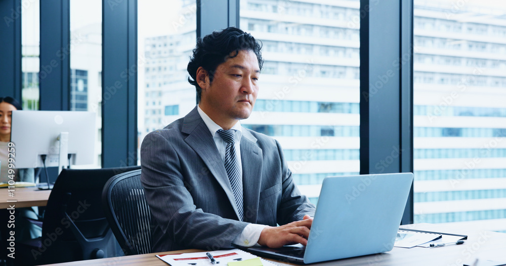 Japan, business and man with laptop, thinking and internet with stock market, connection and network. Asian person, accountant and employee in office, communication and computer for email and typing Japan, business and man with laptop, thinking and internet with stock market, connection and network. Asian person, accountant and employee in office, communication and computer for email and typing