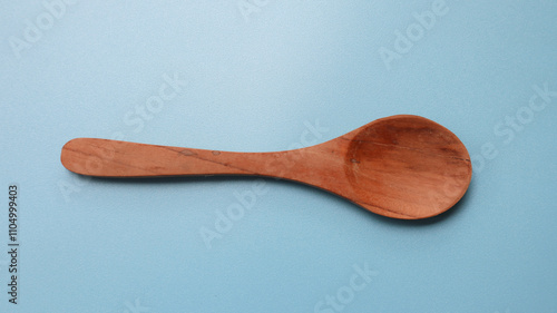 wooden spoon on blue background