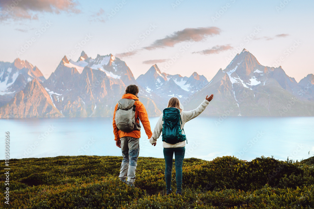 © EVERST - Couple in love hiking travel in Norway man and woman friends holding hands enjoying view, active vacations healthy lifestyle holidays tour outdoor family adventure mountaineering trip in Lyngen Alps