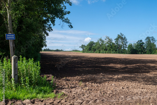 Field of dirt with a sign that says 