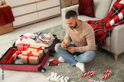Young man planning christma...