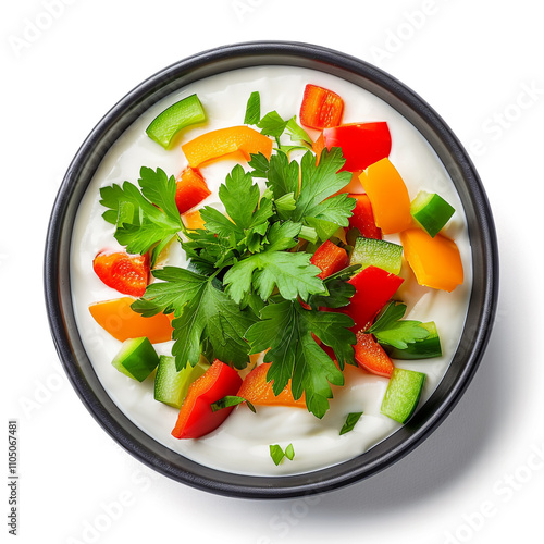 Top view of a bowl of creamy ranch dip with sliced vegetables photo