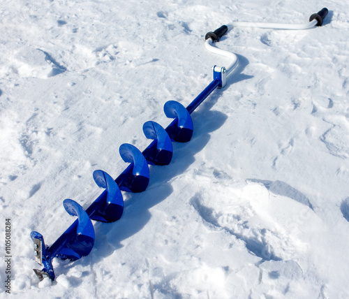 A blue and white snow shovel with a blue handle and a blue handle photo