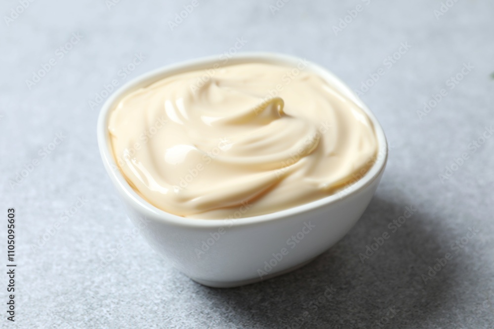 Bowl with mayonnaise on gray background Bowl with mayonnaise on gray background