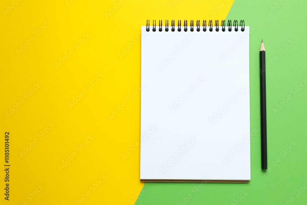 Flat lay with notebook and pencil on color background, top view Flat lay with notebook and pencil on color background, top view