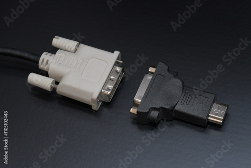 Obraz na płótnie DVI to HDMI adapter closeup on black background, hardware used for converting digital video signals between display devices. Macro shot of DVI to HDMI adapter on black background. Selective focus w salonie