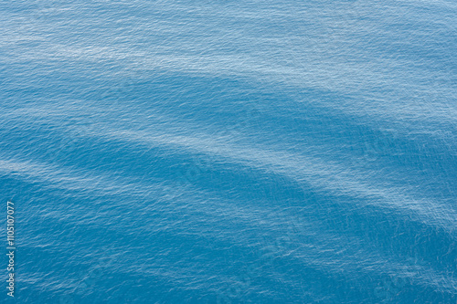 Blue ocean water texture background with gentle waves and ripples. Calm sea surface with light reflections. background wallpaper, Serene and peaceful marine scenery photo