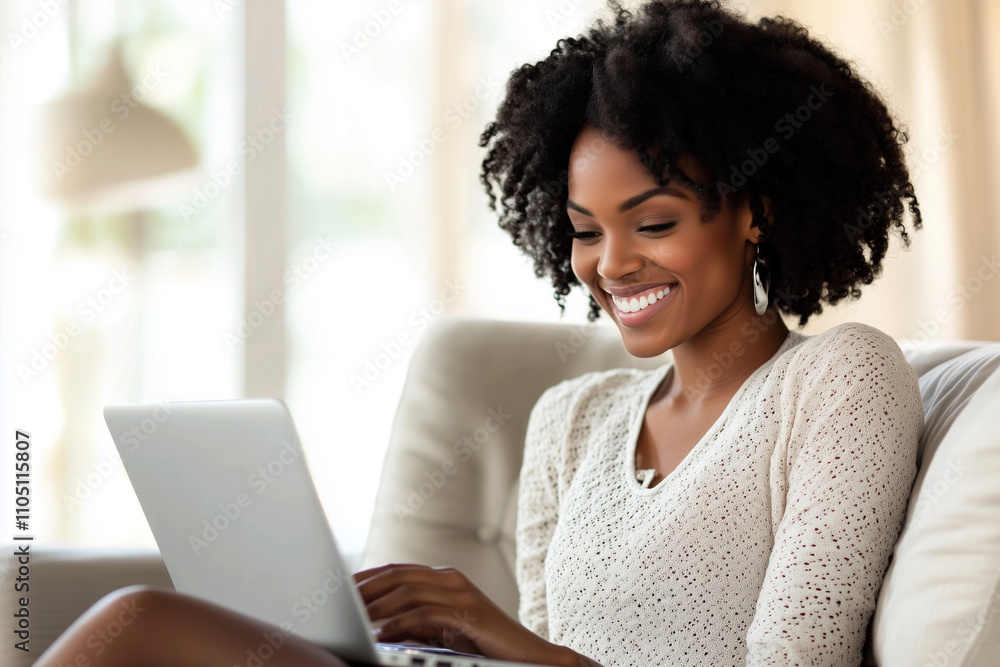 woman is sitting on a couch and smiling while using a laptop. She is happy and relaxed woman is sitting on a couch and smiling while using a laptop. She is happy and relaxed