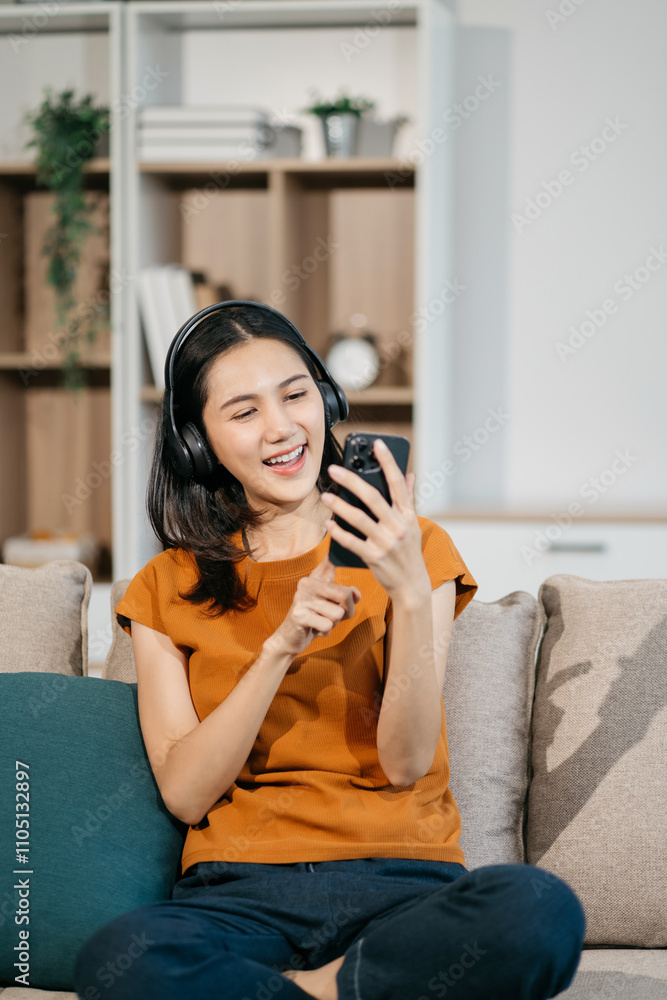 Fototapeta premium lifestyle Happy woman looking at cellphone screen, reading message, or email, communicating distantly with client or playing games from smartphone.