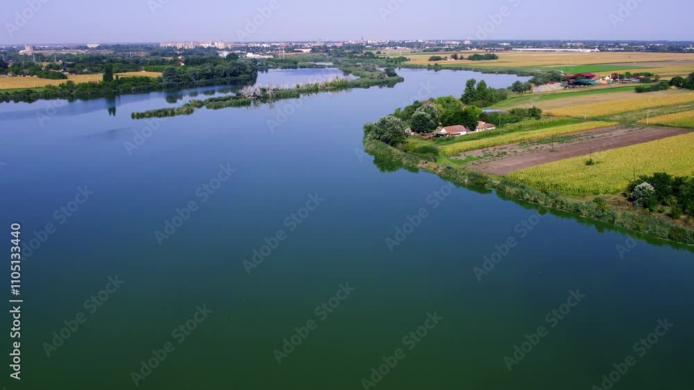 Peaceful river flows through lush green countryside with clear blue skies during daytime Peaceful river flows through lush green countryside with clear blue skies during daytime