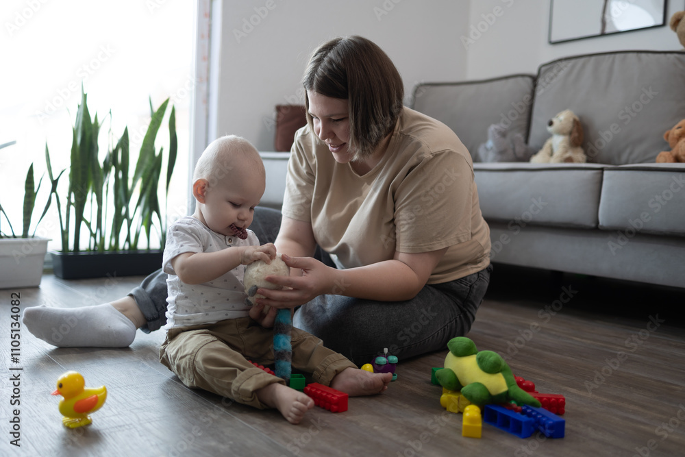 A loving mother enjoys meaningful playtime with her curious toddler in a cozy, vibrant, toyfilled room A loving mother enjoys meaningful playtime with her curious toddler in a cozy, vibrant, toyfilled room
