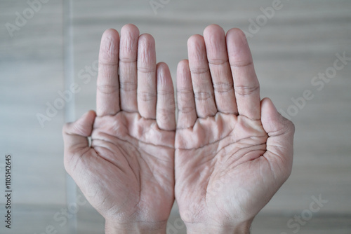 Closeup photo of wrinkled hands and feet after playing in the water for a long time.