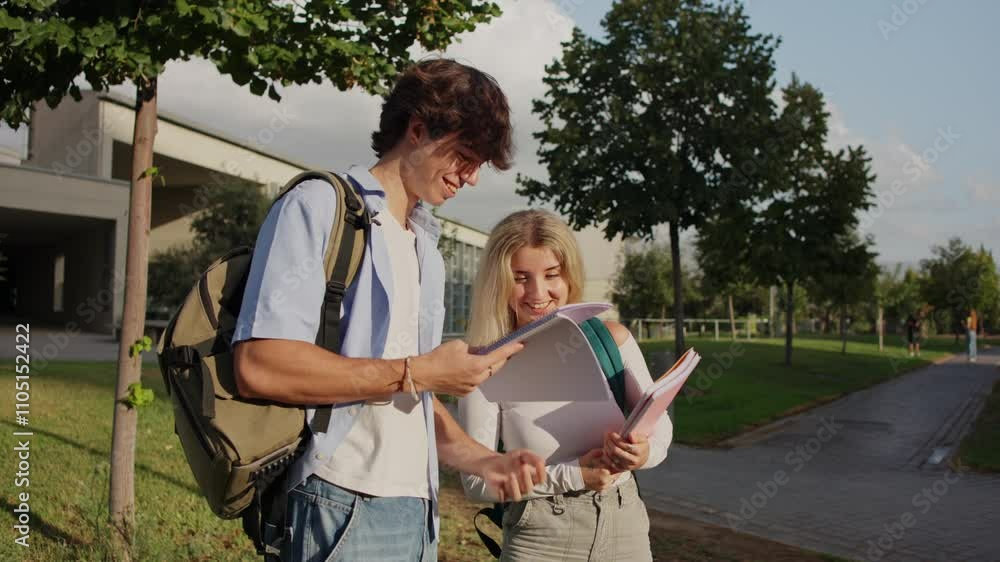 University students discussing and studying on campus pathway University students discussing and studying on campus pathway